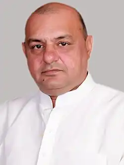 Head shot of Gogi wearing a white shirt