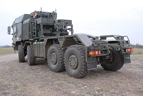 Rear three-quarter shot showing winch assembly of an HX81 8×8 HET with IAC