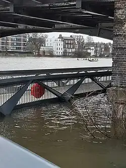 High tide and Storm Henk floodwater up to the bridge's decking, 2024