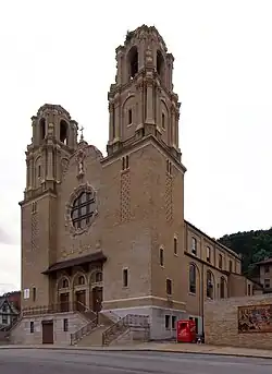A Notre Dame style church with twin steeples and a rose window