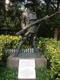 Statue of an anonymous World War I soldier from statuary collection of Eu Tong Sen. Also visible is the Battle of Hong Kong memorial plaque dedicated to all the defenders of Hong Kong in December 1941 through John Robert Osborn