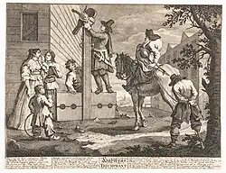 An engraving depicting Hudibras overcoming a fiddle player and placing him in the stocks. Above the stocks, the fiddle and its case are displayed.