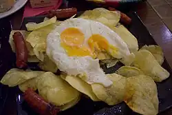 Huevos rotos con chistorra y patatas, a popular dish