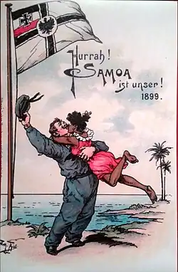 An illustration of a German colonist waving his hat while standing under the Imperial German Reichskriegsflagge on a beach as a Samoan woman jumps into his arms and kisses him. The German text "Hurrah! Samoa ist unser! 1899." is written on the illustration.