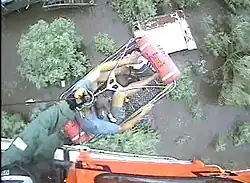 A helicopter rescuing a man from floodwaters in Louisiana