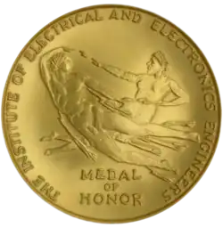 Obverse (face) of the IEEE Medal of Honor showing two figures with lightning bolts passing between their hands