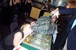 Party goers drinking from ice luges (2003)