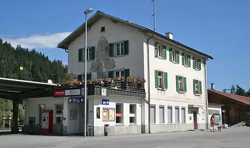 Three-story stone building with gabled roof