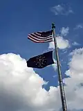 The Indiana flag flying below the American flag.