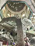 The metal latticework and the interior dome of the dargah