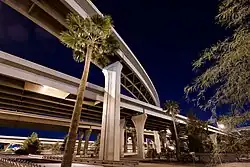 photo showing the multiple levels of roadways at the interchange between Interstates ten and seventeen, called "the stack" in downtown Phoenix at night.