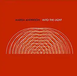 A series of intersecting concentric half circles in white and yellow over a red field. The artist's name is typed in black and the album's name in white above.