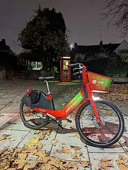 A bright red and green bike in the dark
