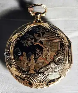 A pocket watch with an intricate Asian-themed design painted on it