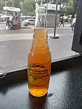 A glass bottle of Jarritos Tamarindo using a bottle design found in Mexico