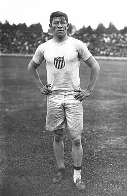 Thorpe standing, wearing a United States Olympic jersey
