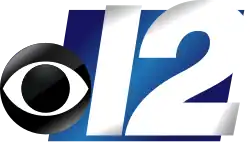 The CBS eye and a shiny slanted white numeral 12 sitting atop a smaller blue parallelogram