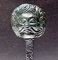 Pin with miniature head sculpture