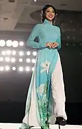 A woman wearing cyan Áo dài