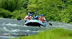 People on a raft paddling trough the river