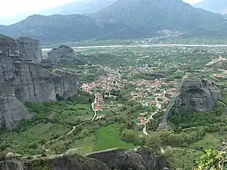View of Kastraki from the Meteora rocks. In the distance is the Pineios River. Upstream is to the right. To the left is Kalabaka. The edge of Holy Spirit Rock is on the right. Surloti Rock is the second-to-last one on the left.