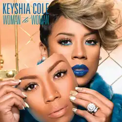 Keyshia Cole staring and holding a mask that resembles her face, set against a strawberry pink background with a gold fence surrounding it. Cole's name appears on the top left, followed by the album title (the first and third/last words "Woman" are styled in all uppercase, with the second word "to" stylized in lowercase) below.