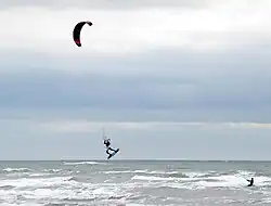 Kite surfer taking to the air at Tyrella beach