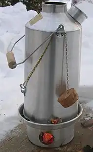 A Kelly kettle, designed to efficiently use the heat of a small fire in a chamber at the base
