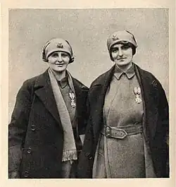 Chisholm and Knocker display their Order of Léopold II, medals. On their headscarves is the insignia of the Belgian Army's 3rd Division, c. 1918
