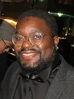 Howery glancing towards a camera