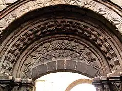 Arch and tympanum over the processional entrance on south side of the church.