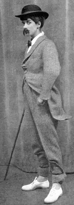 White woman in comedy male costume, wearing blatantly false moustache