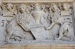 Lions flanking a funerary urn.