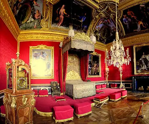 Lit de parade, Salon of Mercury. The clock, by Antoine Morand, was offered to Louis XIV in 1706. It is the only piece of furniture from the Grand Appartement that has survived, however the original Boulle marquetry case has been replaced.