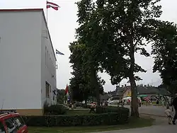 Livonian culture centre in Mazirbe with flags on display during annual meeting.