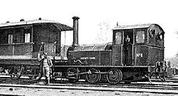 Claude W. Kinder poses with the "China Rocket" steam locomotive