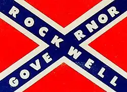Confederate flag with Governor Rockwell written across the blue stripes instead of stars
