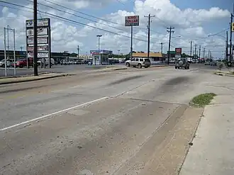 View is SW at Long Point Road and Lynnview. Upthrown side of the Long Point Fault is to the right. Fault passes to the left of the kiosk.
