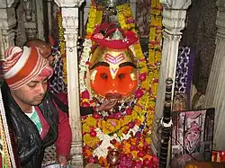 Liquor being offered to the deity
