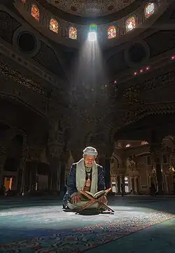 A man reading the Quran inside the moque