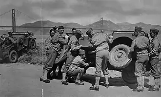 Soldiers manhandle jeep as intended, to fix it. Golden Gate Park, San Francisco.