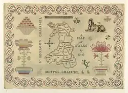 Cloth with various embroidered images; including a map of Wales with traditional counties labelled