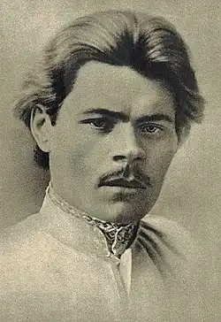 The image is a faded black-and-white photo of writer Maxim Gorky, taken in 1889.