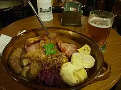 Image 58A "traditional Bohemian platter" at a restaurant in central Prague, consisting of roast duck, roast pork, beer sausage, smoked meat, red and white cabbage, bread, bacon and potato dumplings (from Czech cuisine)