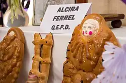 Offerings of bread to the deceased. Q.E.P.D. (Que En Paz Descanse "Rest in peace").