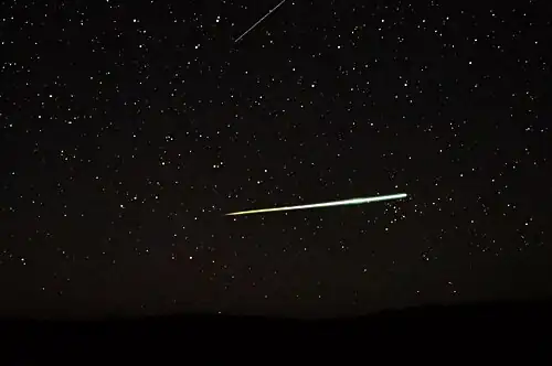 Sporadic bolide over the desert of Central Australia and a Lyrid (top edge)