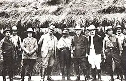 A black-and-white photograph of several men standing and facing the camera