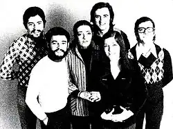 A black-and-white photo of the original six-piece line-up of Mocedades taken in 1973