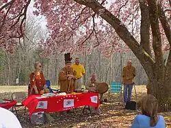 American people in front of a table of Native Virginian artifacts