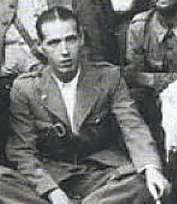 Photograph of Mohamed Saïl sitting on the floor